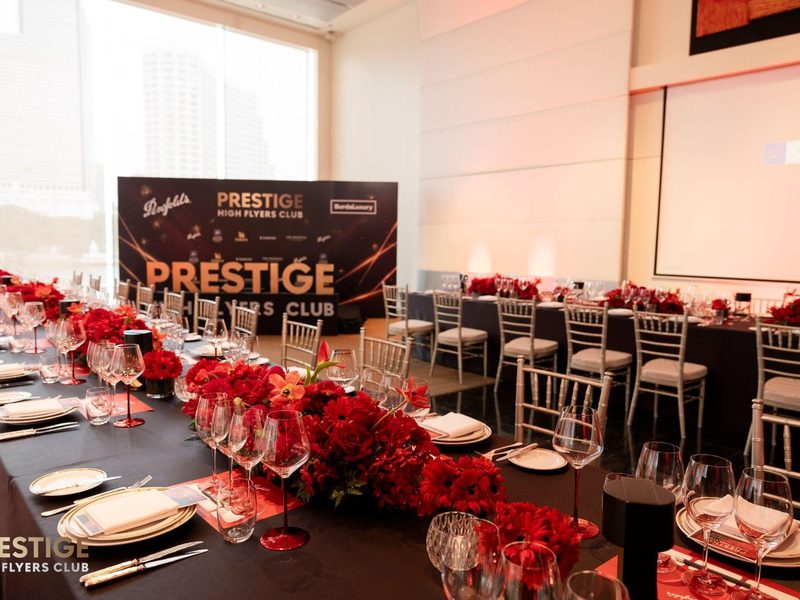 Gala dinner table setting with red floral centerpieces