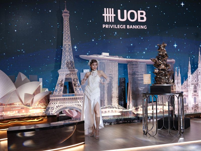 UOB Privilege Banking activation, model on stage in front of global landmark backdrop